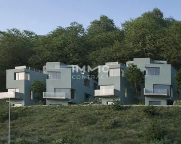 Moderne Reihenhäuser mit kubischer Architektur, eingebettet in eine grüne Hügellandschaft.