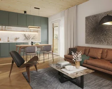 Offener Wohn-Essbereich mit moderner grüner Küche, Holzboden und gemütlichem Sofa.