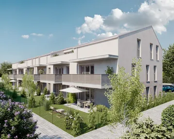 Moderne Wohnanlage mit mehreren Wohneinheiten, Gärten und Balkonen unter blauem Himmel.