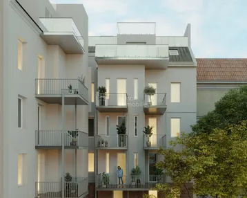 Moderne Wohnfassade mit mehreren Balkonen und Dachterrassen in einem städtischen Umfeld.