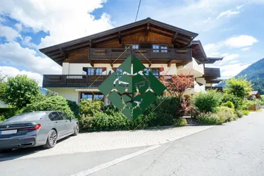 Expose Grundstück mit Apartmenthaus inmitten der Kitzbüheler Alpen zu kaufen