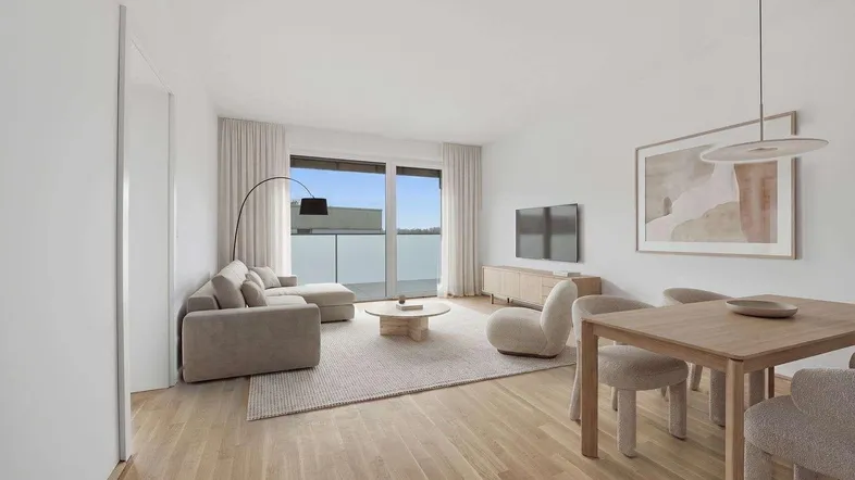 Modern eingerichteter Wohn-Essbereich mit hellem Parkettboden und Zugang zum Balkon.