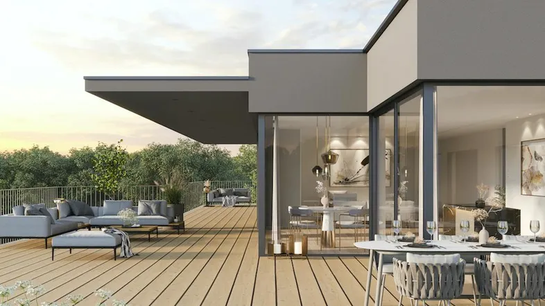 Moderne Dachterrasse mit Essbereich und Lounge-Möbeln, umgeben von Grün und weitem Blick.