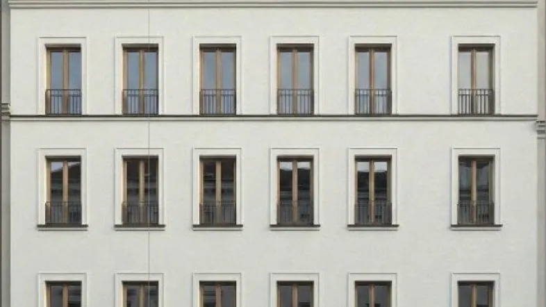 Moderne Gebäudefassade mit weißer Putzfläche, großen Fenstern und einem Café im Erdgeschoss.