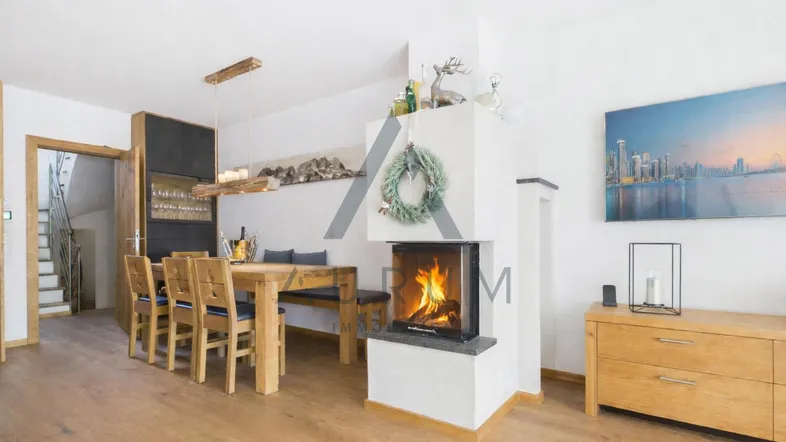 Heller Wohn- und Essbereich mit Eichenparkett, modernem Kamin und stilvollen Holzmöbeln.