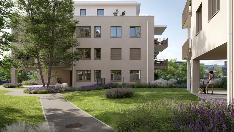 Moderne Wohnanlage mit gepflegten Grünflächen und Wegen, umgeben von Bäumen und Sträuchern.