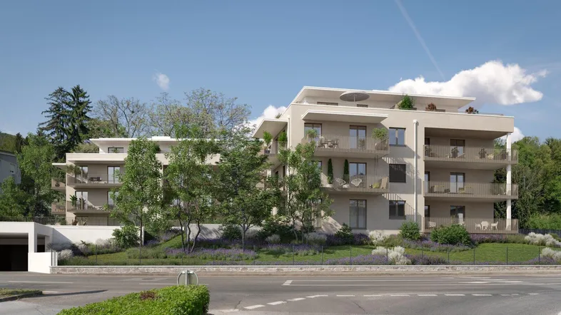 Moderne Wohnanlage mit mehreren Balkonen und Tiefgaragenzufahrt in grüner Umgebung.