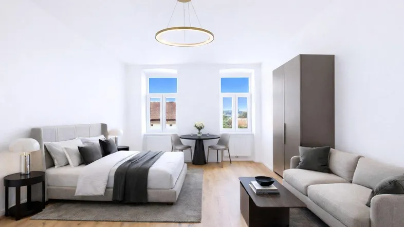 Helles, modern eingerichtetes Studio-Apartment mit Schlaf- und Wohnbereich sowie Blick ins Grüne.