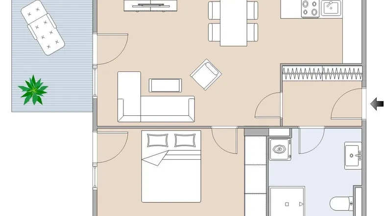 Grundriss einer Wohnung mit Schlafzimmer, offenem Wohnbereich und Balkon.