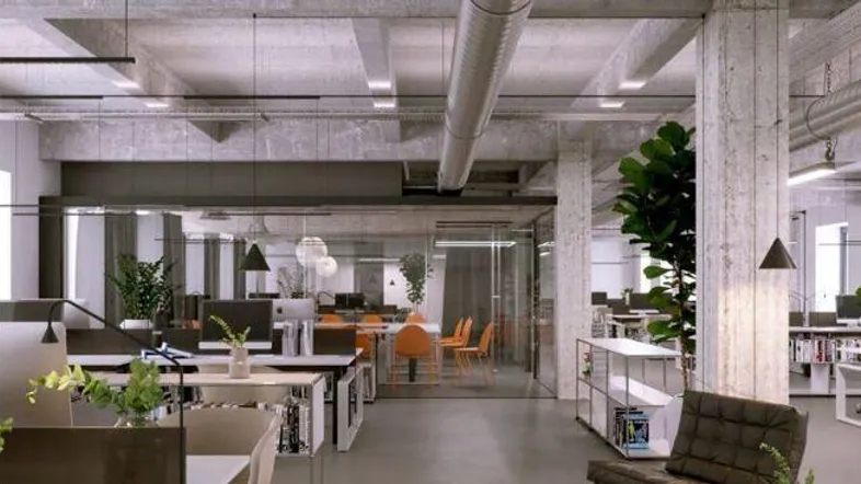 Modernes Großraumbüro mit Sichtbetonwänden, hohen Decken und industriellem Design.
