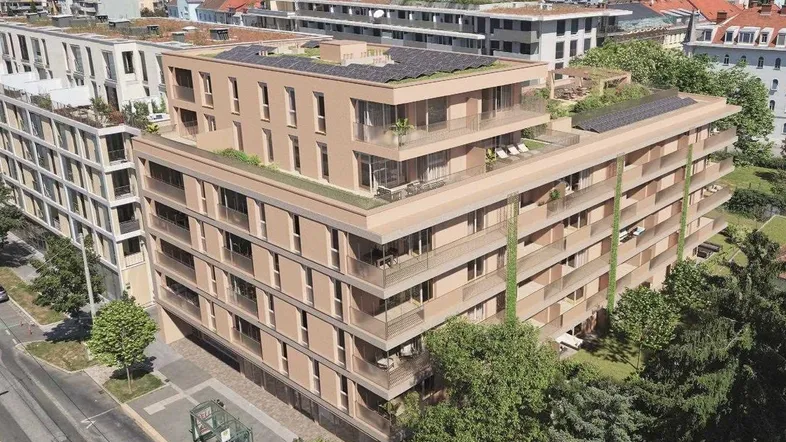 Moderne Wohnanlage mit mehreren Etagen, begrünten Dächern und Balkonen in städtischer Umgebung.
