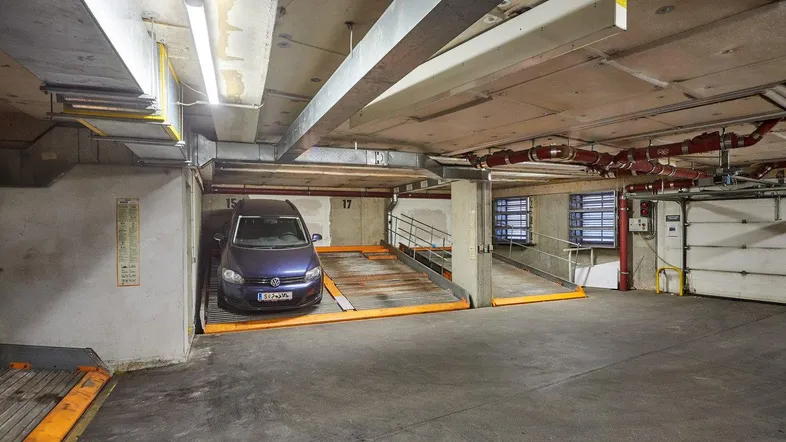 Tiefgarage mit einem geparkten Fahrzeug auf einer modernen Hebebühne für effizientes Parken.