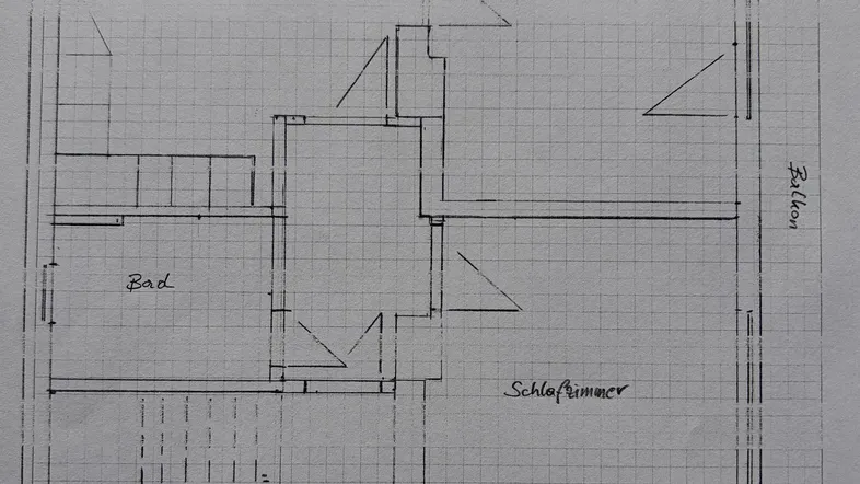 Grundriss einer Wohnung mit Wohnküche, Wohnzimmer, Schlafzimmer, Bad und Balkon.