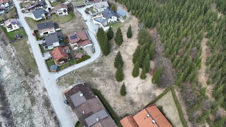 Luftaufnahme einer Wohnsiedlung am Waldrand mit Blick auf die umliegende Natur.