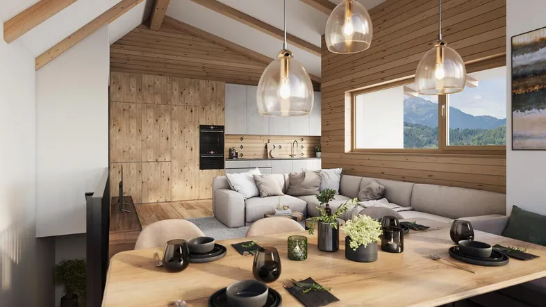 Heller offener Wohnbereich mit Holzbalken, moderner Küche und Bergblick.
