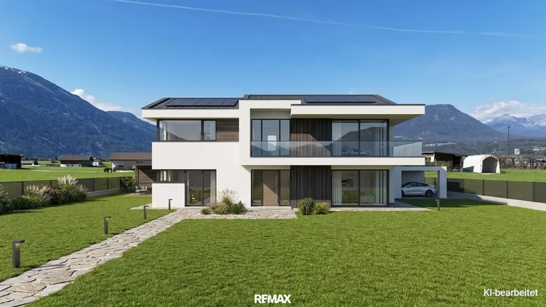 Modernes Einfamilienhaus mit Flachdach, großen Fenstern und Bergblick in sonniger Lage.
