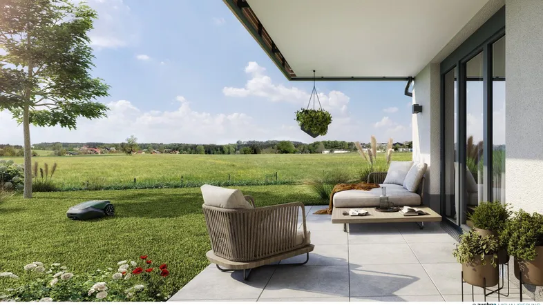 Helle Terrasse mit modernen Gartenmöbeln und weitem Blick über die grüne Landschaft.