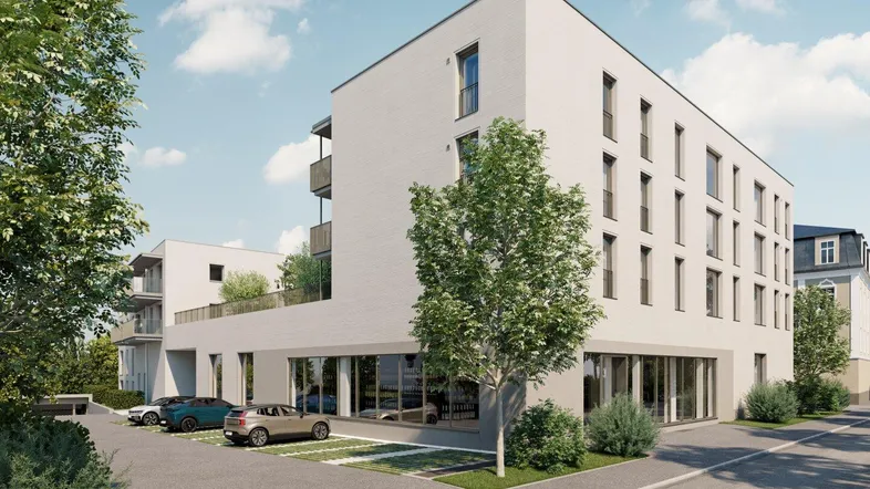Moderne weiße Fassade eines Neubaus mit großen Fenstern und Parkplätzen im Freien.
