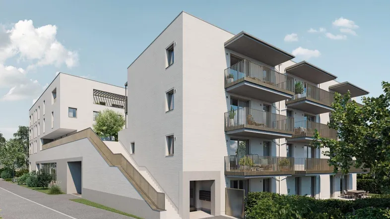 Modernes Mehrfamilienhaus mit Balkonen, Außentreppe und schlichter Fassadengestaltung.