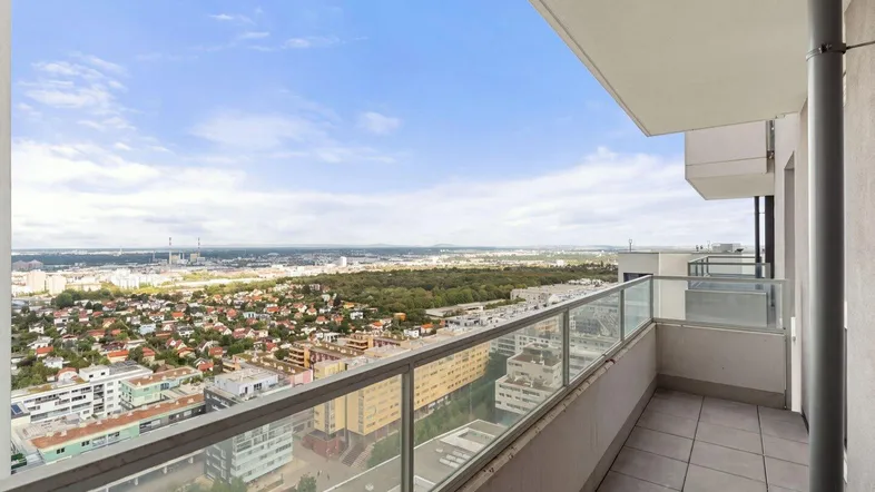 Geräumiger Balkon mit Fliesenboden und weitem Blick über die Stadt und die Umgebung.