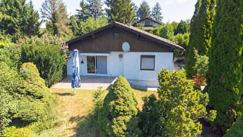 Einfamilienhaus mit gepflegtem Garten, Terrasse und viel Grün in sonniger Lage.