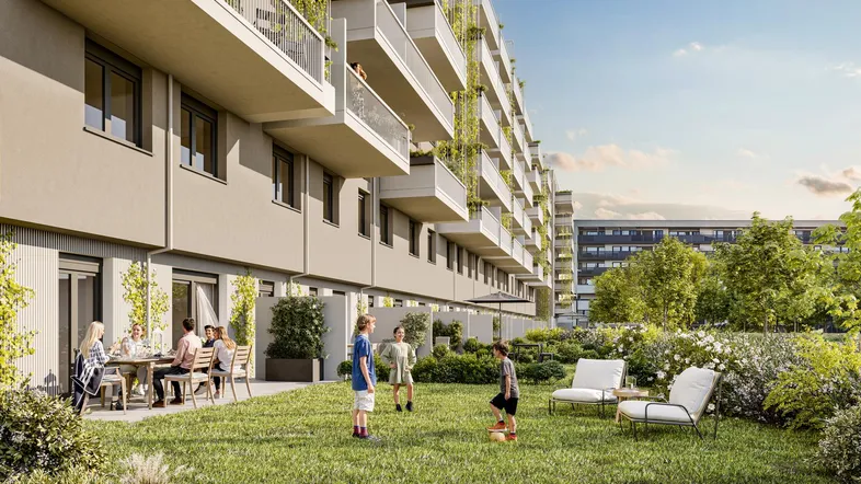 Moderne Wohnanlage mit großem Gemeinschaftsgarten und Spielbereich für Kinder.