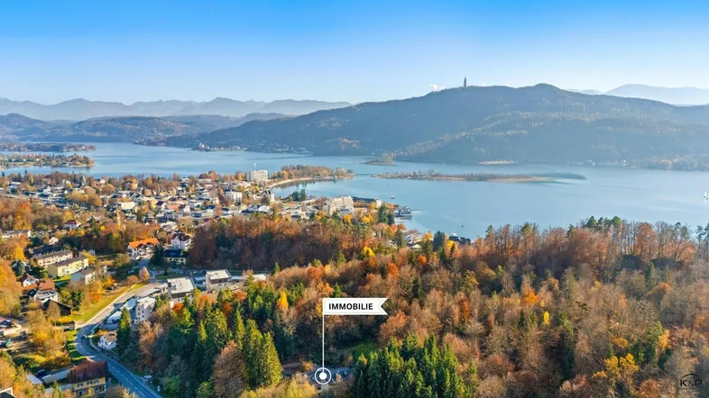 Panoramablick auf die Immobilie in einer malerischen Landschaft mit See und Bergen.