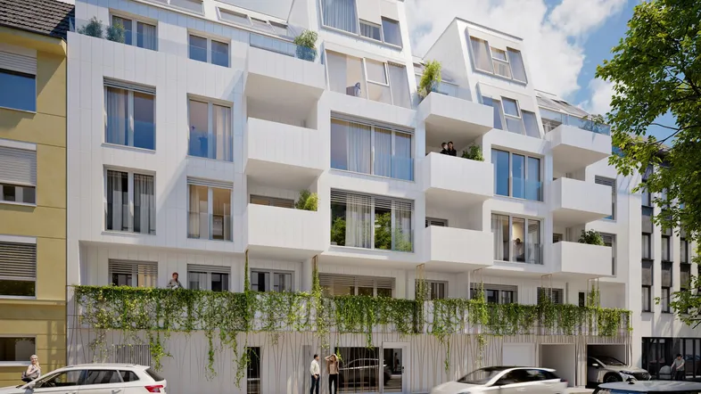 Moderne Wohnanlage mit weißer Fassade, Balkonen und begrüntem Erdgeschossbereich an der Straße.