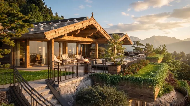 Luxuriöses Chalet mit großer Terrasse, gemütlichen Sitzgelegenheiten und atemberaubendem Bergblick bei Sonnenuntergang.