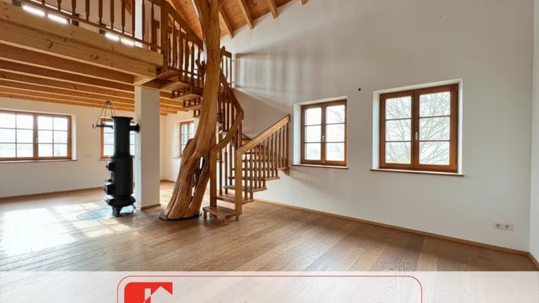 Geräumiger, offener Wohnbereich mit einzigartiger Holztreppe aus Baumstamm, Holzboden und gemütlichem Kaminofen.