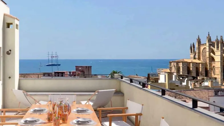 Große Dachterrasse mit Esstisch, Meerblick und Blick auf die Kathedrale von Palma.