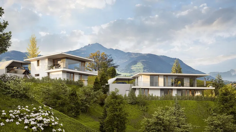 Zwei moderne Villen in Hanglage mit großen Glasfronten und beeindruckendem Bergblick.