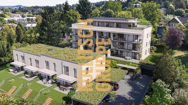 Moderne Wohnanlage mit begrünten Dächern, Balkonen und Carports, eingebettet in eine grüne Umgebung.