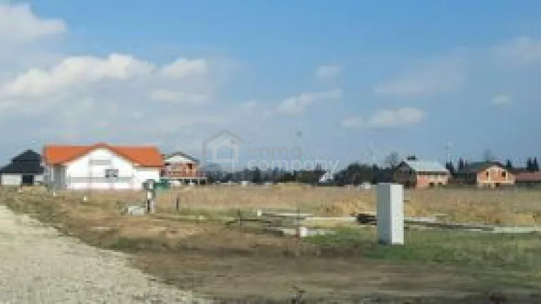 Weitläufige Landschaft mit mehreren Wohnhäusern unter blauem Himmel, ideal für ländliches Wohnen.