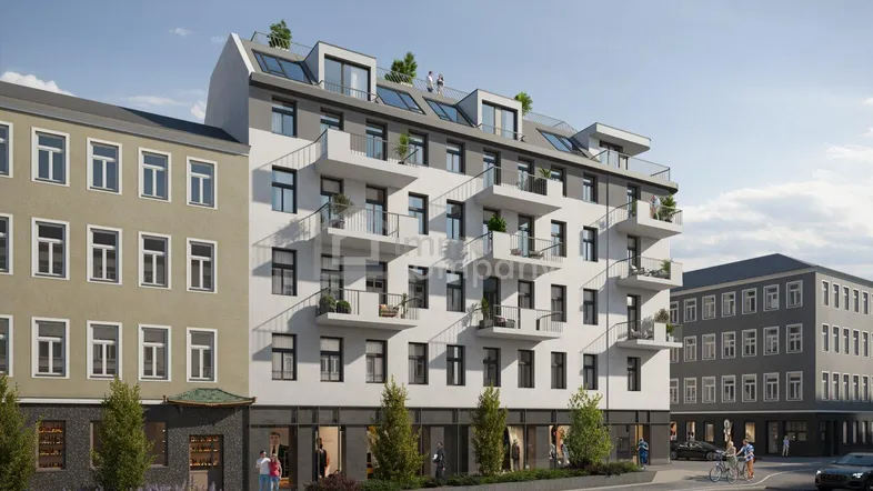 Moderne Wohnanlage mit weißer Fassade, zahlreichen Balkonen und Geschäften im Erdgeschoss.