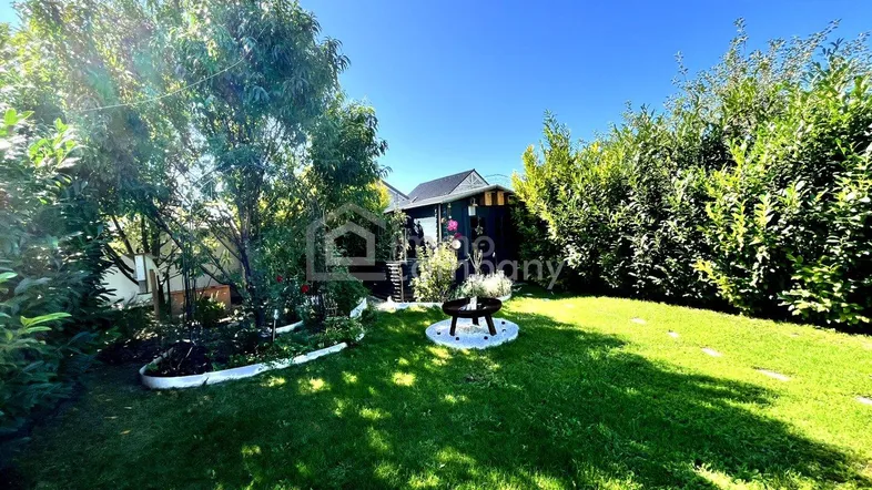 Garten mit Blick auf Feuerstelle und Hütte