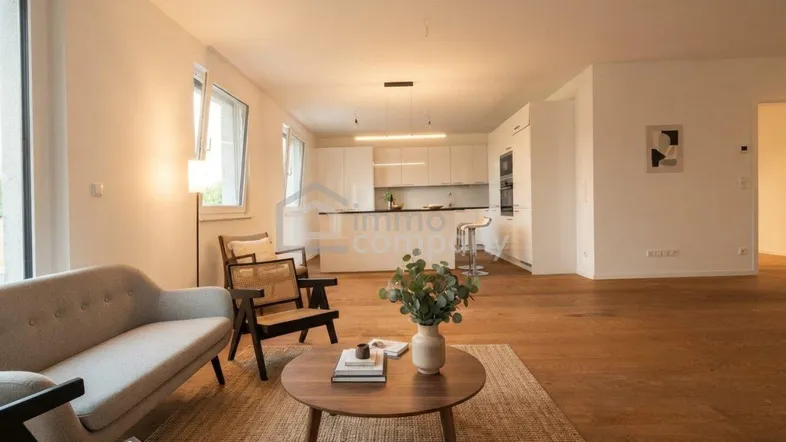 Modernes, offenes Wohnzimmer mit Holzboden, bequemen Möbeln und integrierter Küche.