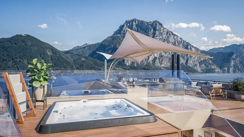 Große Dachterrasse mit Whirlpool, Lounge-Bereich und atemberaubendem Blick auf den See und die Berge.