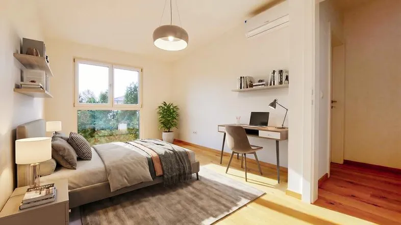 Helles Schlafzimmer mit Holzboden, großem Fenster und modernem Arbeitsbereich.