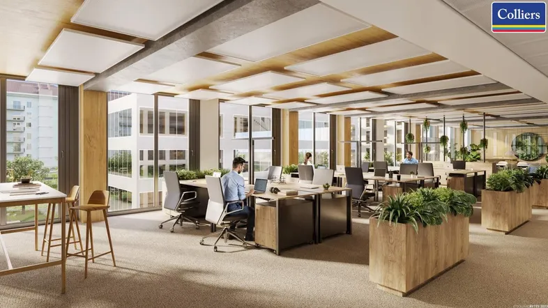 Modernes Großraumbüro mit ergonomischen Arbeitsplätzen, großen Fenstern und viel Tageslicht.