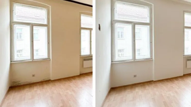 Leerer Raum mit Parkettboden und großen Fenstern, der Renovierungsbedarf aufweist.
