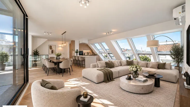 Modernes Penthouse mit lichtdurchflutetem Wohnbereich, offener Küche und Dachschrägenfenstern.