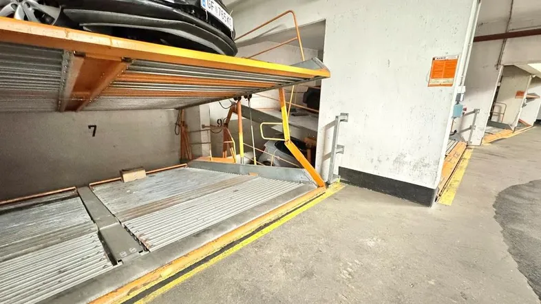 Automatisches Parksystem in einer Tiefgarage mit einem geparkten Auto auf der oberen Plattform.