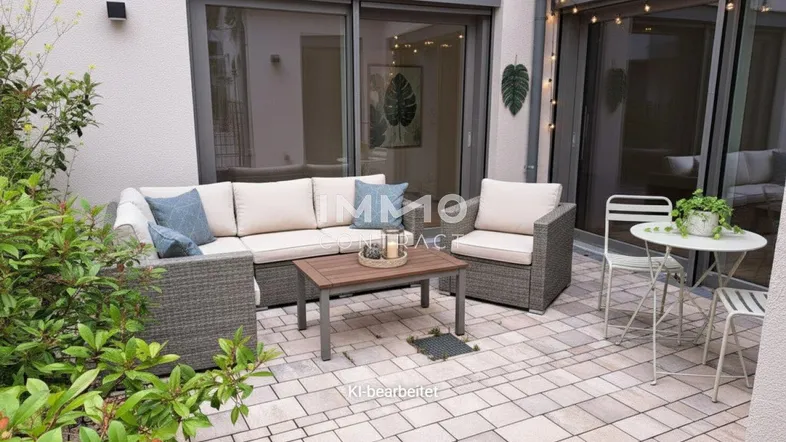 Gemütliche Terrasse mit modernen Outdoor-Möbeln und Zugang zum Innenbereich, ideal für entspannte Stunden.
