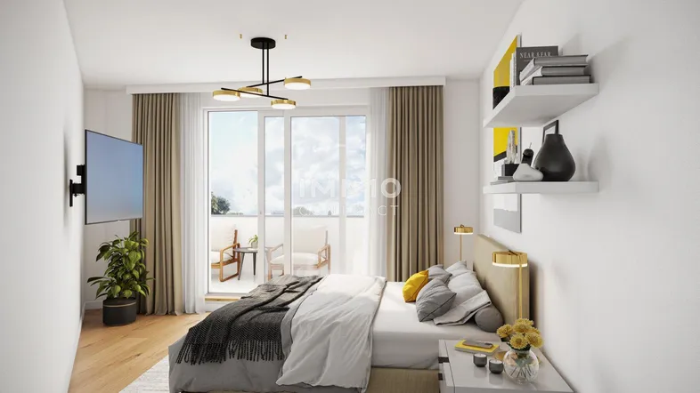 Helles Schlafzimmer mit Holzboden, Zugang zum Balkon und moderner Einrichtung.
