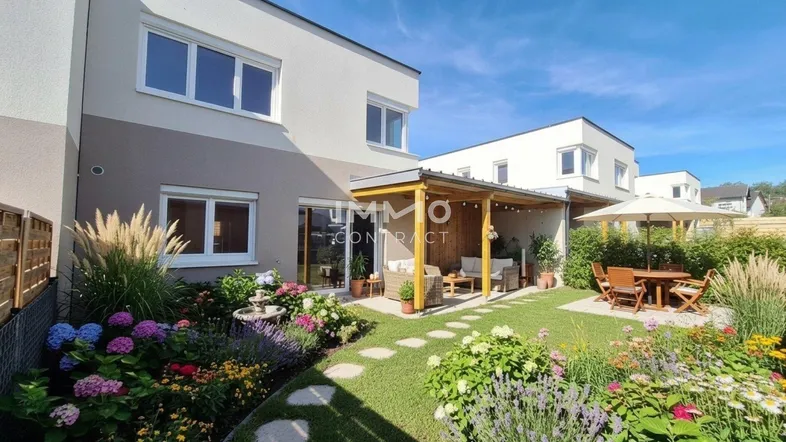 Gepflegter Garten mit überdachter Terrasse, Essbereich und blühenden Pflanzen hinter dem modernen Haus.