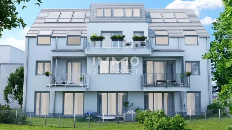 Modernes Mehrfamilienhaus mit heller Fassade, mehreren Balkonen und einem gepflegten Gartenbereich.