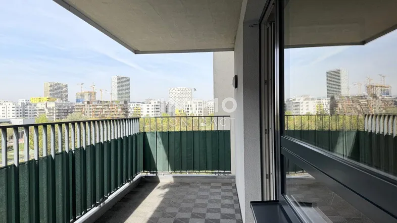 Geräumiger Balkon mit Stadtblick und praktischem Bodenbelag, ideal für entspannte Stunden im Freien.