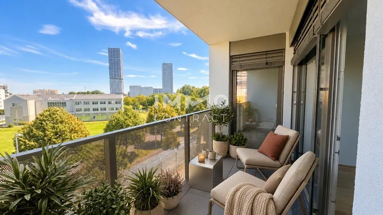 Möblierter Balkon mit Pflanzen und weitem Blick auf die Stadt und moderne Gebäude.