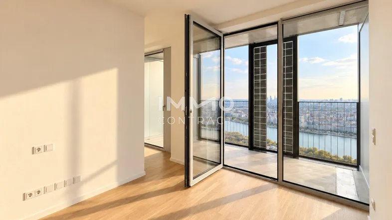 Helles Zimmer mit Holzboden und raumhohen Fenstern, die einen weiten Blick auf die Stadt und den Fluss bieten.